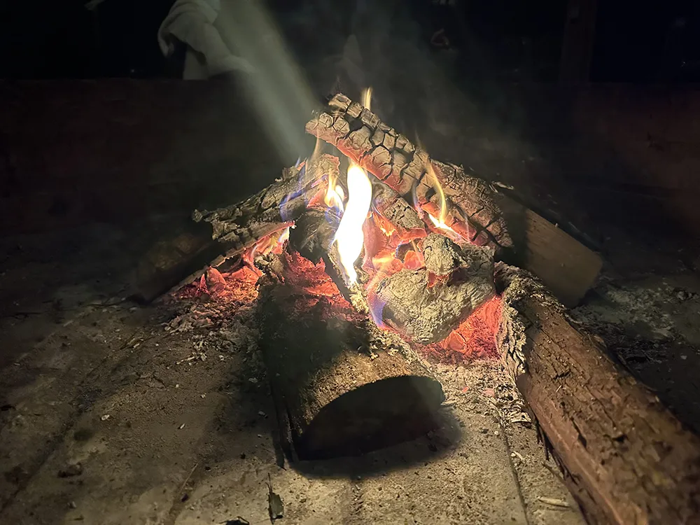 Fire burning in a ceremonial setting during an ayahuasca retreat in Colombia.
