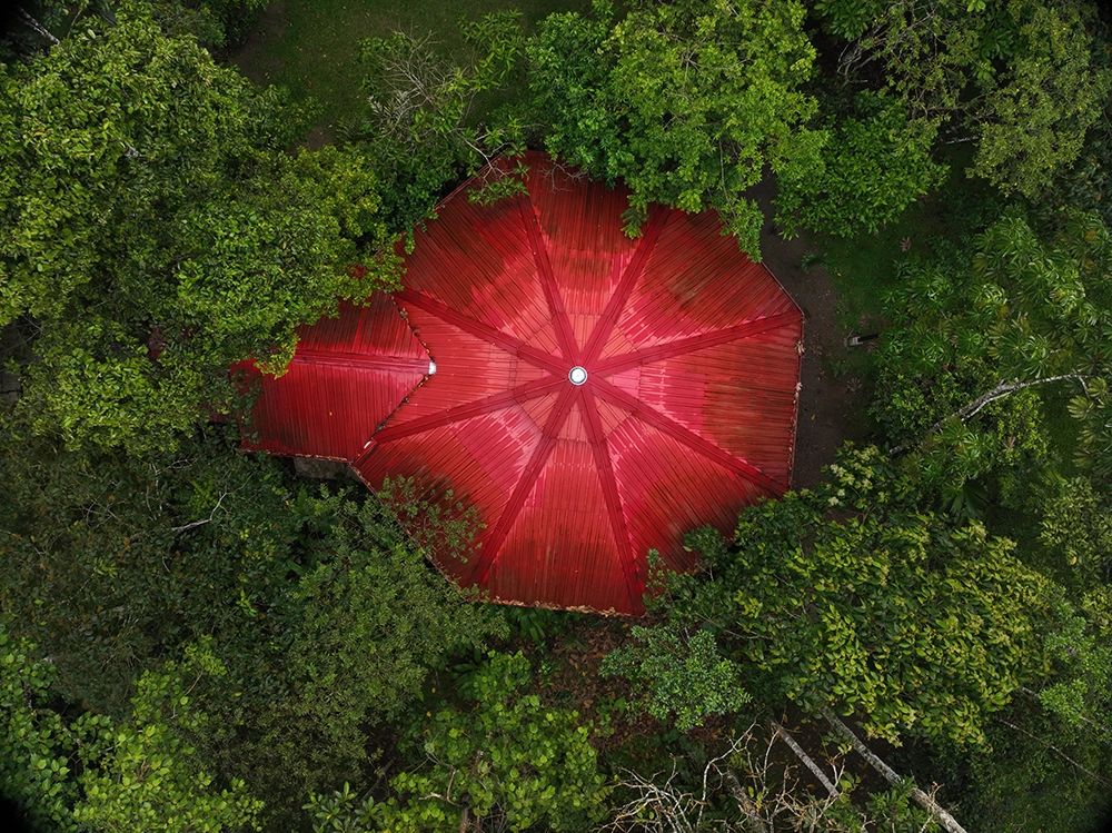 Aerial view of the ceremonial maloka surrounded by jungle at a safety-focused luxury ayahuasca retreat in Colombia.
