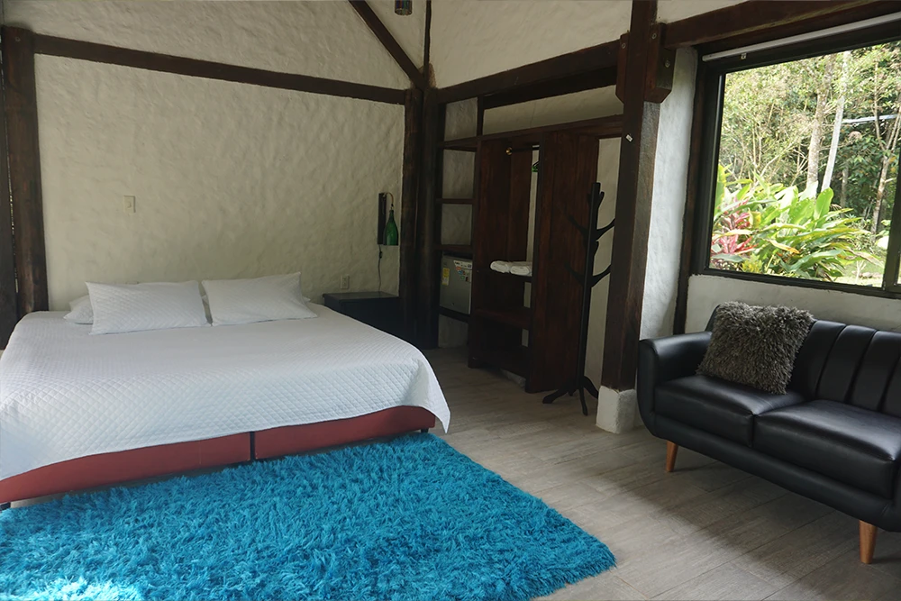 King-size bed in premium modern room at Mahadevi Ayahuasca Retreat