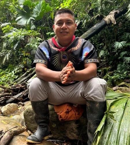 Taita Miguel, an indigenous elder of the Camsá tribe, smiling and wearing traditional ceremonial necklaces.