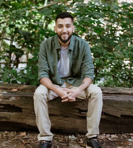 Yasha Shah, founder of Mahadevi Ayahuasca Retreat, sitting in the Amazon jungle.